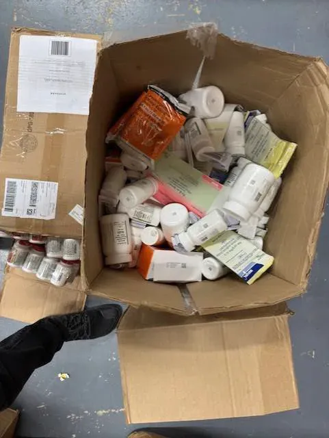 An open box of loose bottles and cartons with no padding